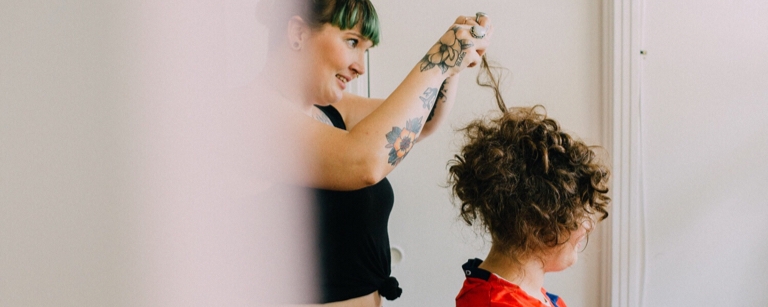 An insured Hair salon employee styling a client's hair

