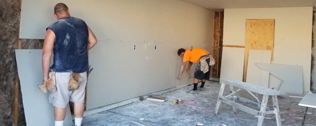 Contractors hang dry-wall