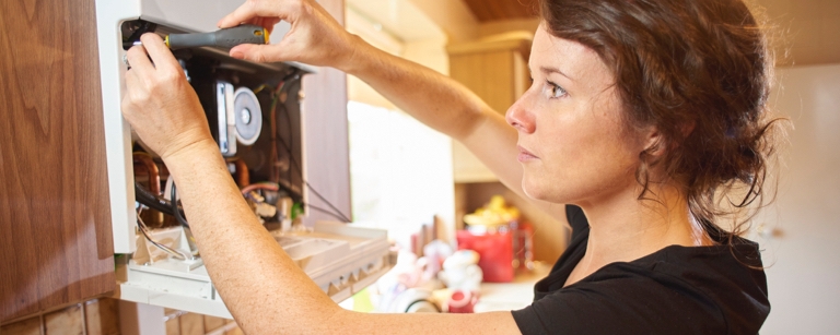 A woman wiring an appliance