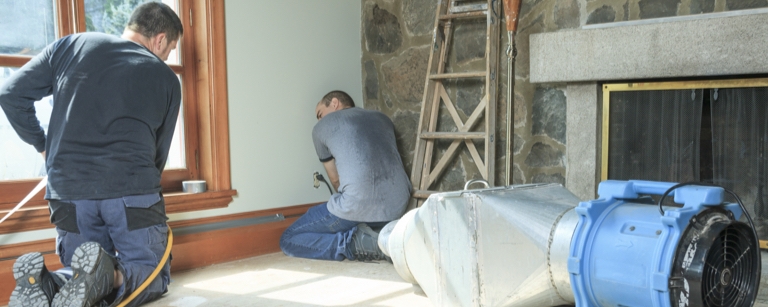 Contractors with a home improvement insurance installing a house 