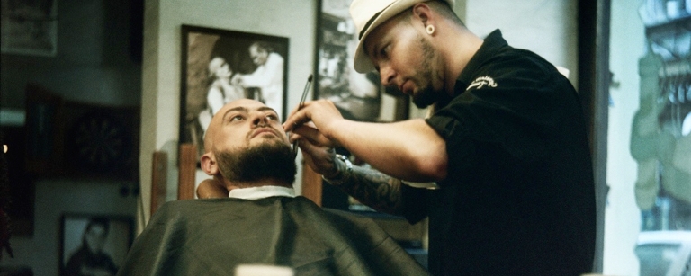 Barber trimming a client's beard