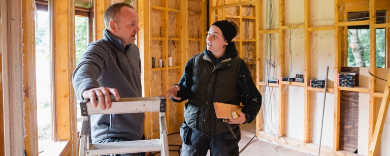 Subcontractors discussing how to build a house