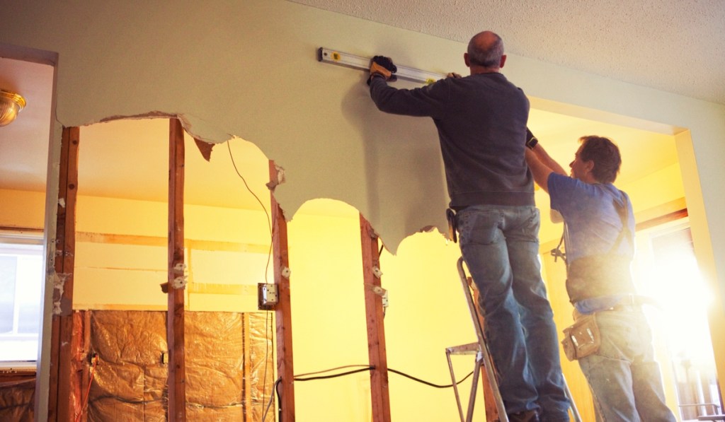 Protecting your small business means you can focus on your work, like this contractor on a ladder.