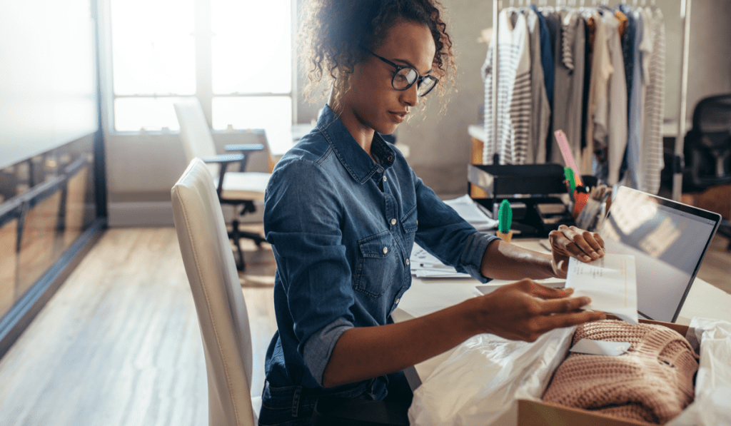 Woman putting a packing slip into a box