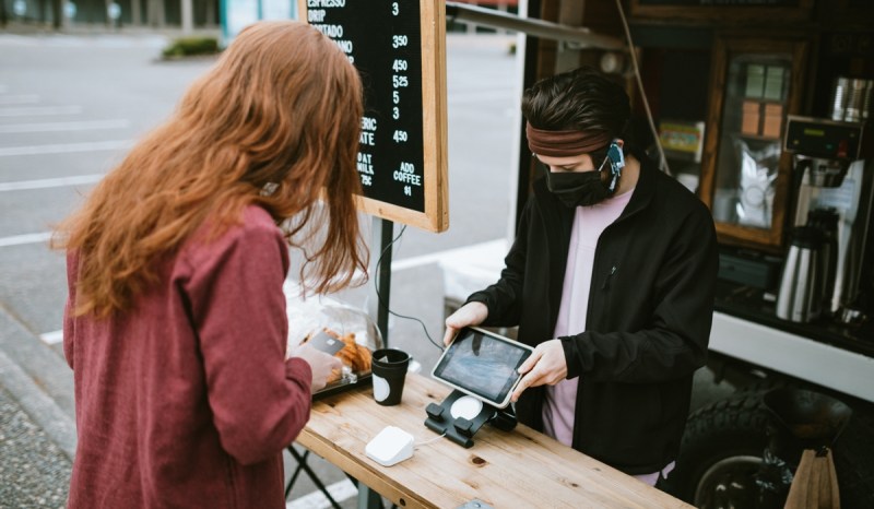 A food truck with a Massachusetts business license cashes out a customer.