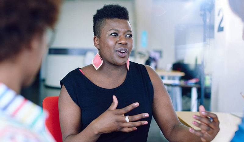 A woman is at a bank learning how to get a small business loan