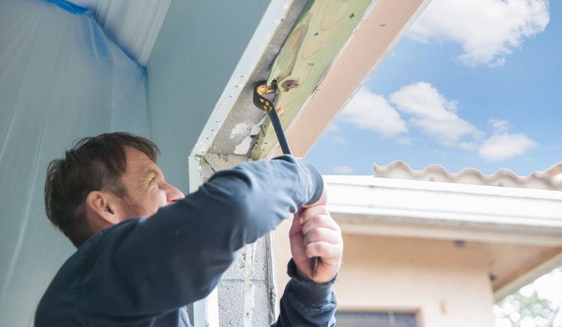 A New Mexico contractor license lets you work on bigger projects, like this contractor in the middle of demoing a door frame.