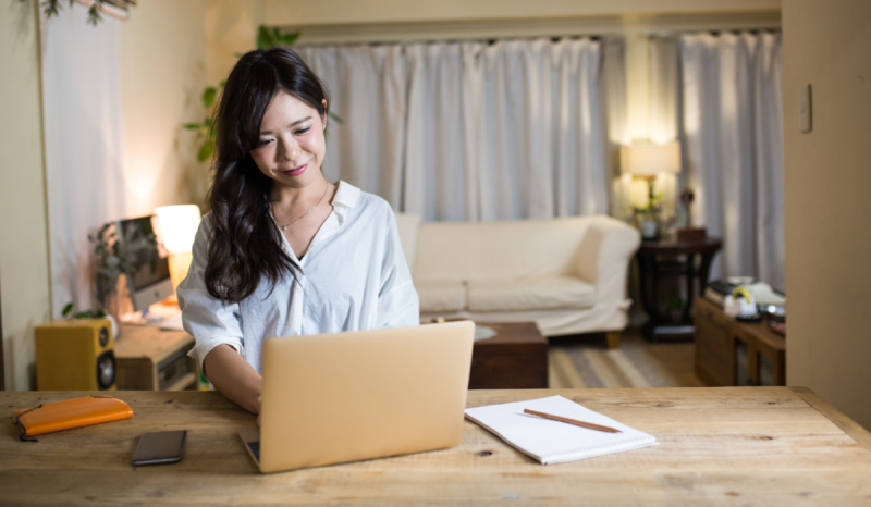 A woman on her laptop learning how to start an LLC.