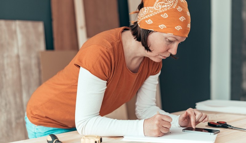 If you’ve always been an excellent carpenter, consider learning how to become a carpenter business owner, like this woman at work.