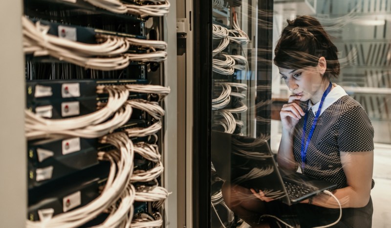 An IT administrator with a Missouri business license examines her laptop.