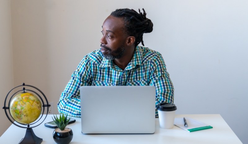 Starting your own freelance business can be done right at your desk, like this man is doing with his laptop.