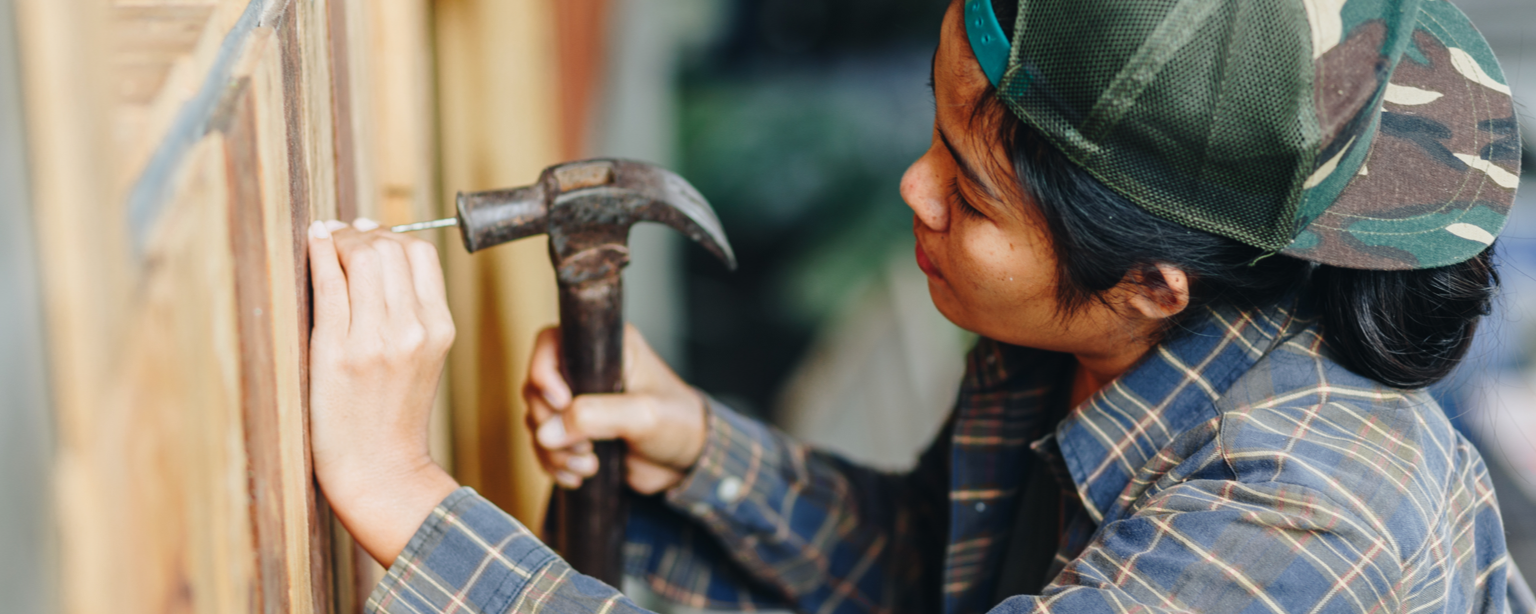 Carpenter with a North Carolina Business Insurance installs cabinets 