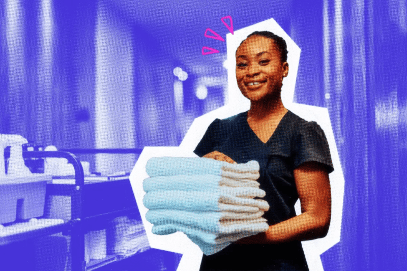 Housekeeper carrying a stack of towels