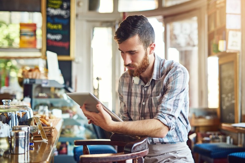 Young business owner looking at a tablet device