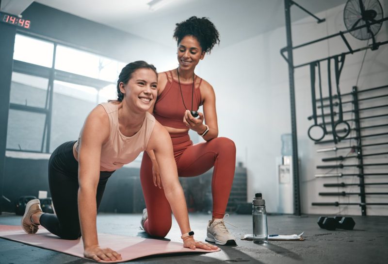 Personal trainer helping client