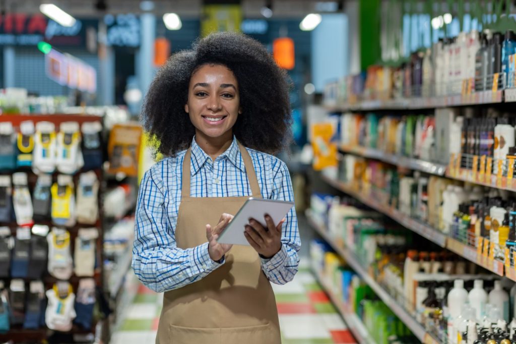 Seasonal employee standing between shelves