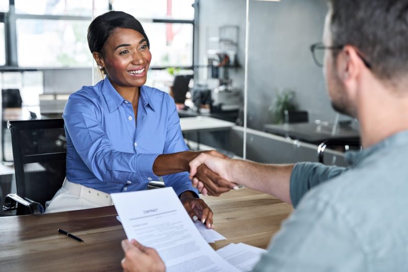 Insurance professional shakes a person's hand