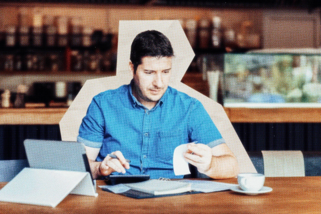 Business owner at a table working on taxes.